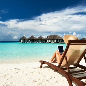 Young woman with tablet pc at the beach